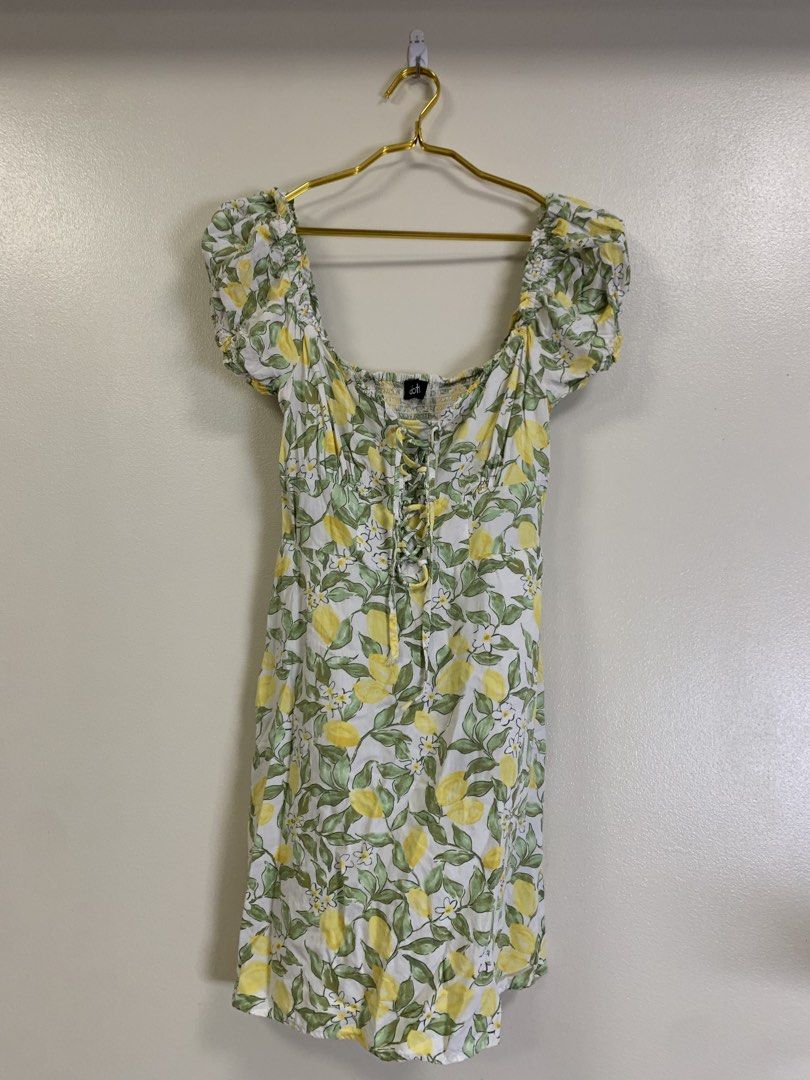 Doti Lemon Print Square Neck Dress (Category: Dresses) located in Davao. Submitted by 2ndbase.dvo.ii (Listing ID 1466599622, Image 1). Description: White midi dress covered in yellow lemons and green leaves. Square neckline with stretchy smocked back bodice. Front lace-up tie closure and puffy short sleeves. Lightweight fabric, great for warm weather outings. Tagged Doti brand inside..