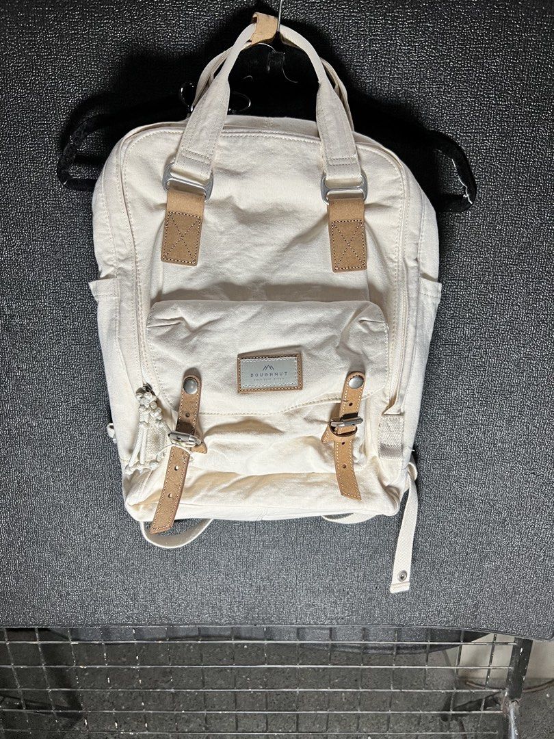 Doughnut Organic Cotton Cream Backpack (Category: Backpacks) located in Taytay. Submitted by cside1900 (Listing ID 1466698389, Image 1). Description: - Material: Premium cream organic cotton with stylish brown leather-look accents - Comfort: Adjustable shoulder straps and back panel with breathable mesh padding - Storage: Multiple interior organizing compartments and secure back zipper closure - Details: Chic metal hardware on the front pocket an