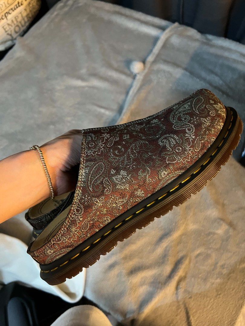 Dr Martens Mules (Category: Casual Shoes) located in Muntinlupa City. Submitted by yungbruh66 (Listing ID 1466720967, Image 2). Description: - Brand: Dr. Martens - Style: Slip-on Mules - Size: EU 41 / UK 7 / US 8 - Color/Pattern: Brown with gold paisley tapestry design - Features: Iconic yellow welt stitching, durable air-cushioned soles, comfortable inner lining - Condition: Excellent pre-loved condition with clean treads.