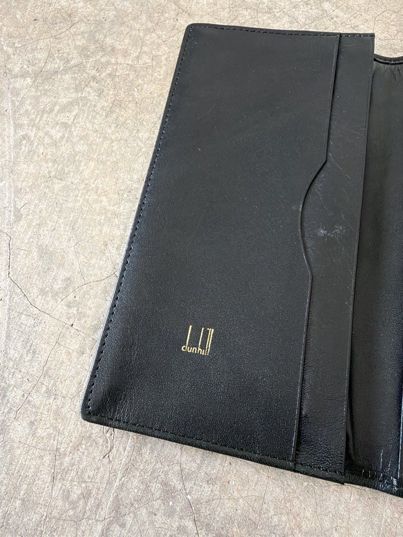 Dunhill Black Leather Long Wallet (Category: Wallets & Card Holders) located in Alfonso. Submitted by jbcamet (Listing ID 1466567457, Image 3). Description: - Brand: Dunhill - Material: Premium black leather - Hardware: Elegant gold-tone corner accents and front logo plate - Interior: Multiple card slots and spacious slip pockets for cash/receipts - Details: Gold-stamped logo inside the flap with clean lining - Fit: Structured, slim shape that ea