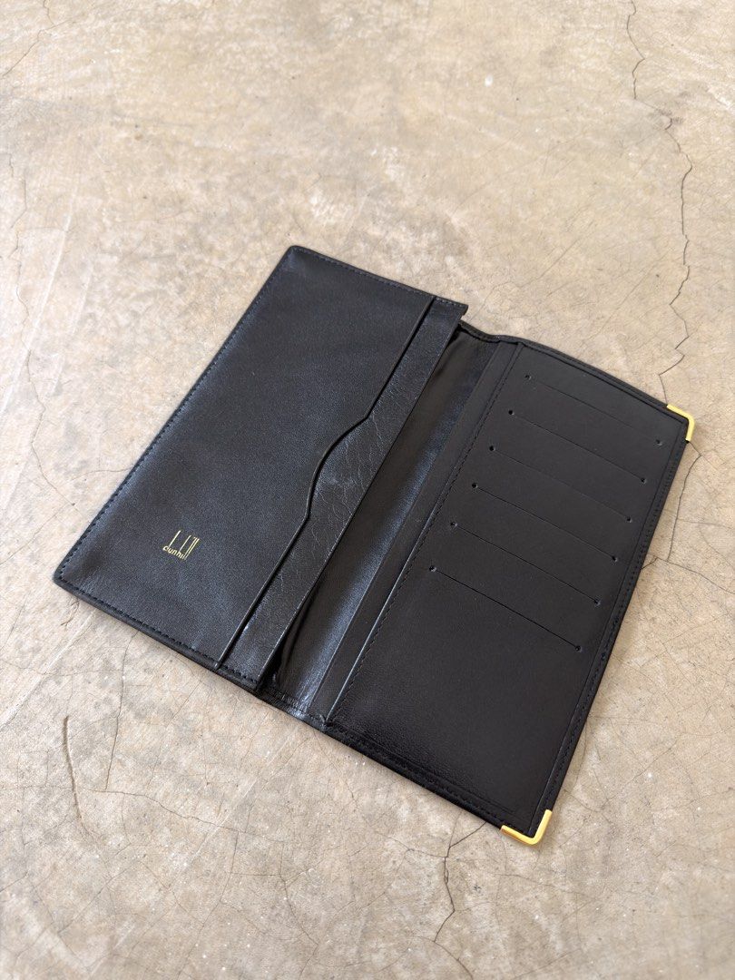 Dunhill Black Leather Long Wallet (Category: Wallets & Card Holders) located in Alfonso. Submitted by jbcamet (Listing ID 1466567457, Image 2). Description: - Brand: Dunhill - Material: Premium black leather - Hardware: Elegant gold-tone corner accents and front logo plate - Interior: Multiple card slots and spacious slip pockets for cash/receipts - Details: Gold-stamped logo inside the flap with clean lining - Fit: Structured, slim shape that ea