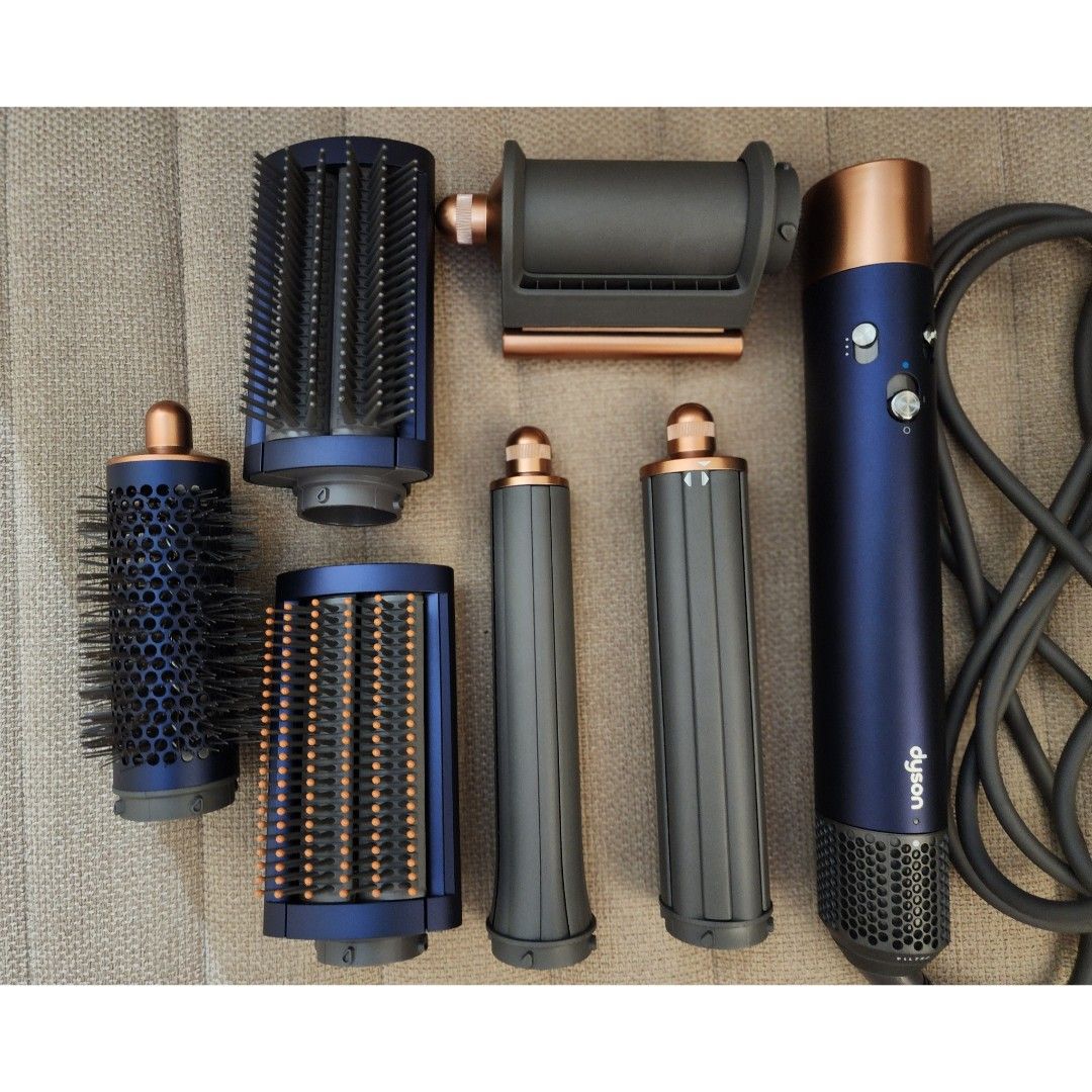 Dyson Airwrap Multi-Styler 6 in 1 Complete Long (Prussian Blue) (Category: Hair) located in Mandaluyong City. Submitted by aaa25 (Listing ID 1466717006, Image 3). Description: Bought at Dyson Official Store orange app for 26k. Price now in orange app is 31k. Selling for only 18k. All inclusions complete. Used less than 10 times. Clean unit with brushes not used. Loc: Mandaluyong Complete Dyson Airwrap multi-styler set in blue and copper. Includes