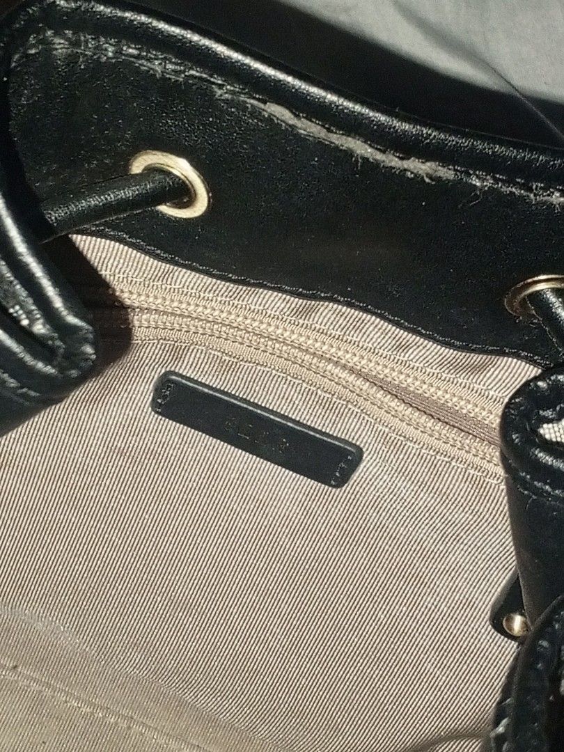 ELLE Monogram Drawstring Bucket Bag (Category: Luxury Bags & Wallets) located in Manila. Submitted by sengfigther06francis (Listing ID 1466618802, Image 2). Description: featuring an all-over monogram jacquard or woven pattern paired with black leather trim, a rigid top handle, and a drawstring closure. The interior is lined in a tan fabric, complete with a zippered pocket and a ELLE gold brand label..