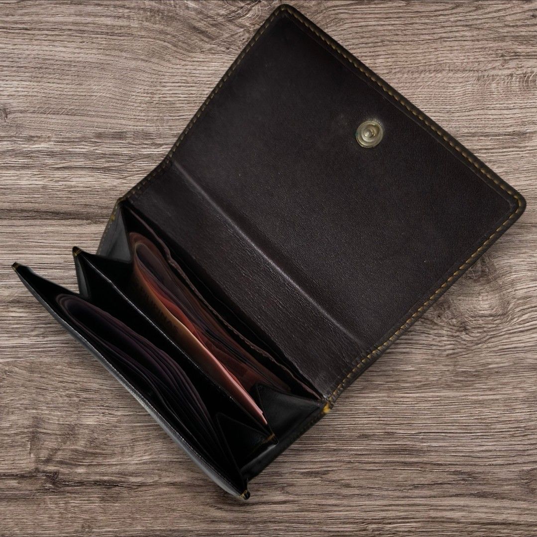 Elle Paris Brown Leather Wallet (Category: Wallets & Card holders) located in Manila. Submitted by ri_ca_purse_selection (Listing ID 1466587672, Image 2). Description: - Brand: Elle Paris - Color: Dark brown leather - Design: Contrast stitching and stamped front logo - Closure: Secure snap button - Storage: Multiple card slots and spacious bill compartments - Style: Classic folded, compact size that easily fits in a bag or pocket.