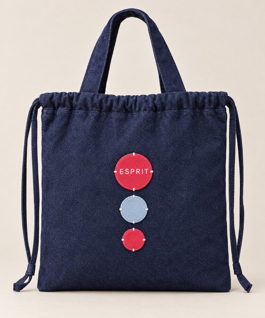 💯ESPRIT Denim Drawstring Tote Bag (Category: Tote Bags) located in Mandaluyong City. Submitted by arlene2560 (Listing ID 1466608173, Image 1). Description: 💯 ESPRIT DENIM TOTE BAG. NWOT. Decluttering P1800. Mandaluyong - Color: Dark blue / Indigo - Material: Clean denim fabric - Closure: Drawstring top with side pulls - Handles: Two top handles for easy carrying - Design: Three decorative stitched round patches on the front (two red, one light 