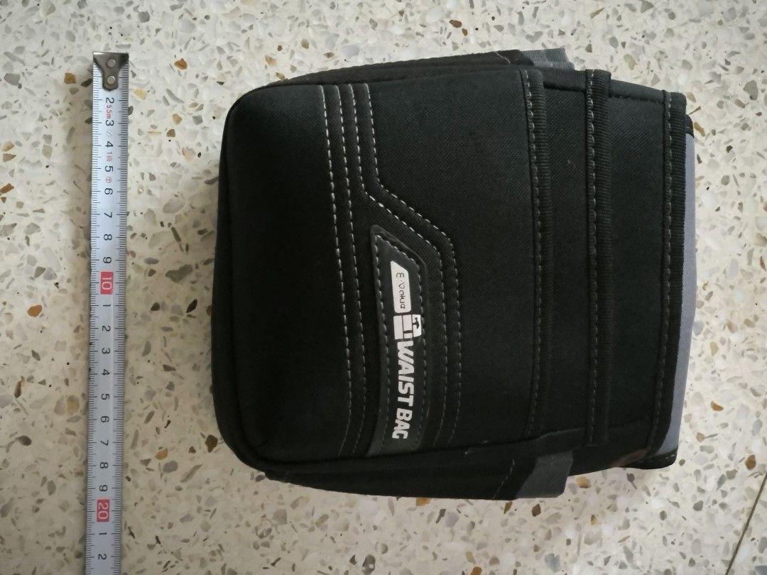 E-Value Tool Waist Bag Utility Pouch (Category: Belt bags, Clutches and Pouches) located in Angeles City. Submitted by yellowbrickstore (Listing ID 1466639388, Image 2). Description: - Brand: E-Value - Color: Heavy-duty black fabric with stylish grey trim and contrast stitching - Storage: Multiple front pouches and side slots for organized tool storage - Durability: Sturdy belt loop back reinforced with metal rivets - Condition: Clean interior co