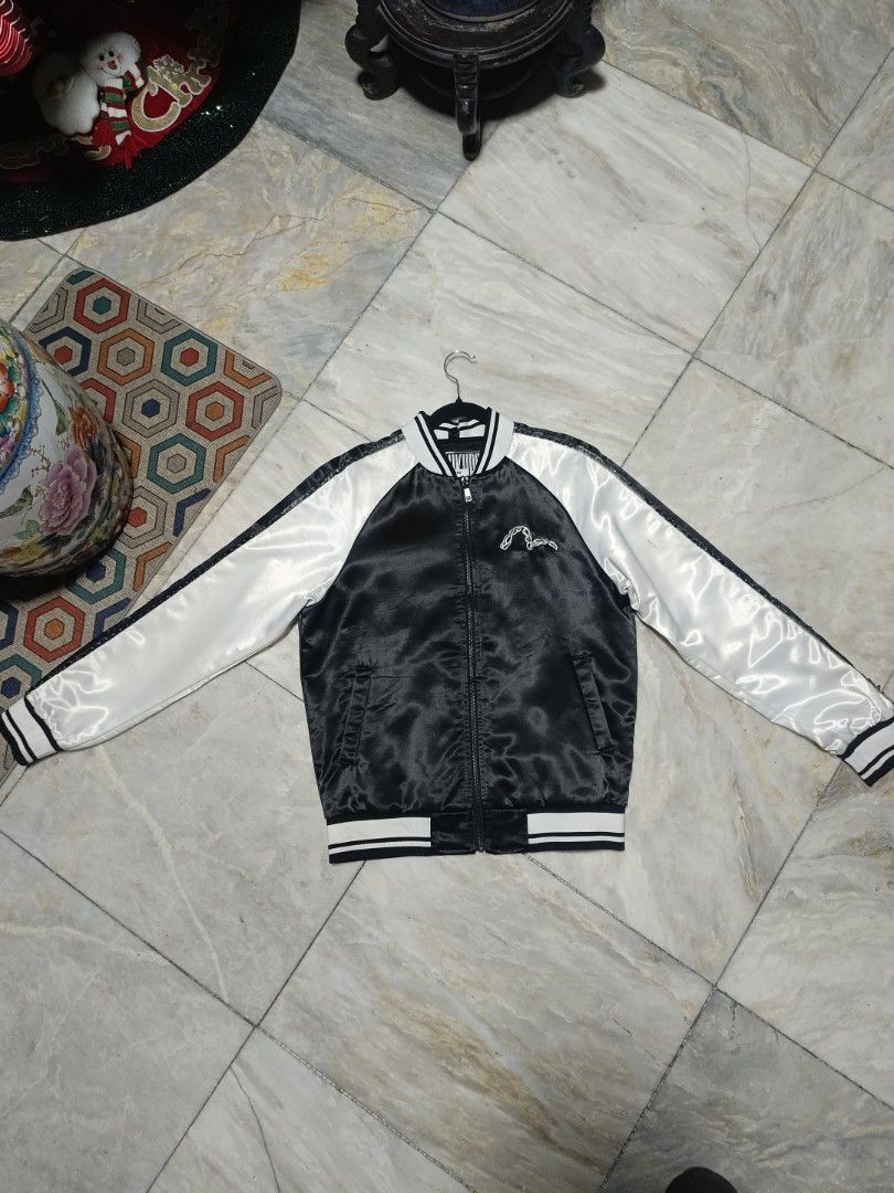 Evisukuro Black And White Bomber Jacket (Category: Coats, Jackets and Outerwear) located in Manila. Submitted by jaymarkmcacuyong (Listing ID 1466754567, Image 1). Description: - Brand: Evisukuro - Style: Bomber jacket (Zip-up closure) - Color: Black and white - Size: M - Design: Bold graphic skull and text prints on the back, small chest logo, striped ribbed cuffs and hem - Material: 100% polyester (Shell and lining) - Care: Machine wash cold - 