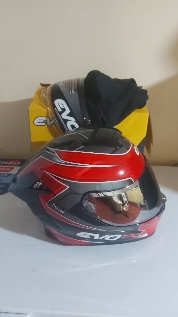 EVO Cyclone Full Face Motorcycle Helmet with Extra Visor (Category: Motorbikes for Sale) located in Manila. Submitted by pretty0099 (Listing ID 1466627892, Image 3). Description: EVO Cyclone full face helmet in red, black, and white. DOT certified safety rating. Comes with the original box and a spare tinted visor. Glossy finish with aerodynamic spoiler design. Interior padding is clean and intact. Never used outdoors, only opened for photos..