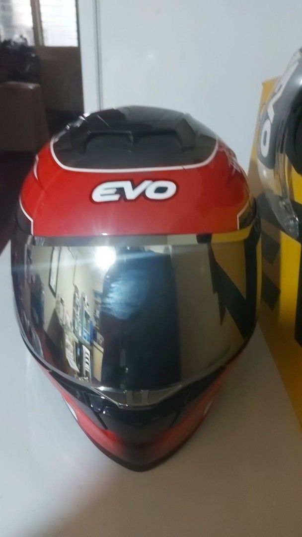 EVO Cyclone Full Face Motorcycle Helmet with Extra Visor (Category: Motorbikes for Sale) located in Manila. Submitted by pretty0099 (Listing ID 1466627892, Image 2). Description: EVO Cyclone full face helmet in red, black, and white. DOT certified safety rating. Comes with the original box and a spare tinted visor. Glossy finish with aerodynamic spoiler design. Interior padding is clean and intact. Never used outdoors, only opened for photos..