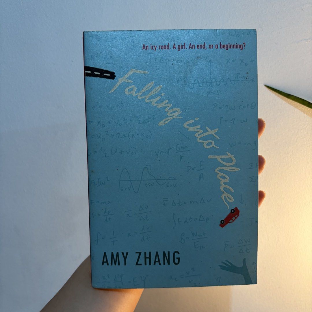 Falling into Place by Amy Zhang (Category: Storybooks) located in Manila. Submitted by ajdeclutter (Listing ID 1466590835, Image 1). Description: - Title: Falling into Place by Amy Zhang - Format: Paperback (Greenwillow Books) - Genre: YA contemporary fiction / emotional teen drama & mystery - Condition: Pages have tanning and foxing along the edges; minor shelf wear on cover - Structure: Spine is straight and binding is completely intact .