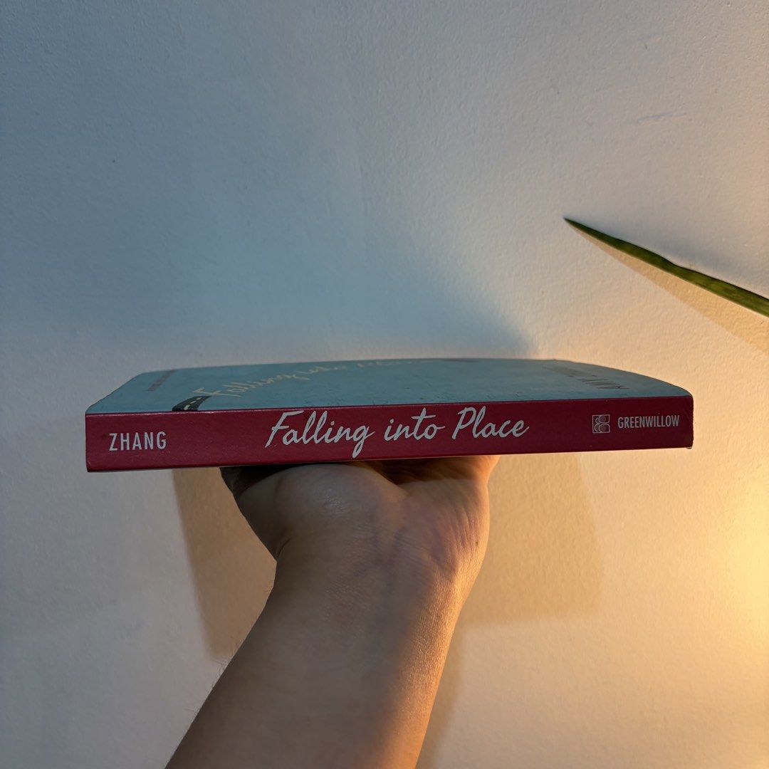 Falling into Place by Amy Zhang (Category: Storybooks) located in Manila. Submitted by ajdeclutter (Listing ID 1466590835, Image 2). Description: - Title: Falling into Place by Amy Zhang - Format: Paperback (Greenwillow Books) - Genre: YA contemporary fiction / emotional teen drama & mystery - Condition: Pages have tanning and foxing along the edges; minor shelf wear on cover - Structure: Spine is straight and binding is completely intact .