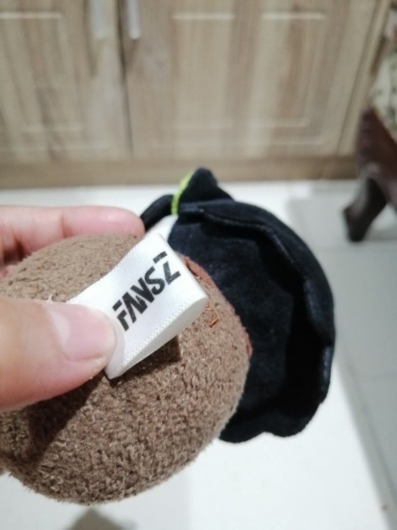 FANSZ Character Plush Keychain (Category: Plushies & Soft Toys) located in Angono. Submitted by rlinee_93 (Listing ID 1466697998, Image 2). Description: - Brand: Authentic FANSZ plush character keychain - Design: Black hair, striking green eyes, and holding a tiny spoon - Details: Brown round base with realistic stitching and signature FANSZ tag - Attachment: Includes a durable green ball chain for easy hanging - Condition: Brand new, perfect for