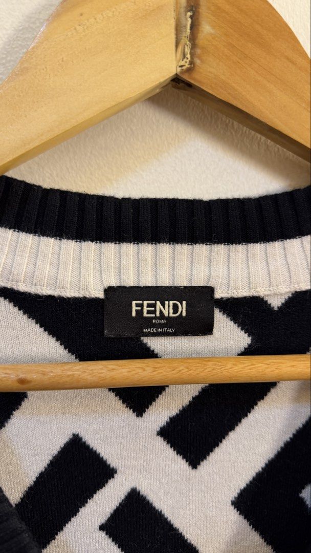 Fendi Roma FF Monogram V-Neck Sweater (Category: Coats, Jackets and Outerwear) located in Paranaque City. Submitted by preluxeshop_ph (Listing ID 1466763536, Image 3). Description: Fendi Roma FF Monogram V-Neck Sweater - Classic V-neck design - Timeless black and white colorway - Ribbed cuffs and hem for a comfortable fit - Made in Italy - Perfect for pairing with trousers or jeans L: 23.5” W: 19.5”.