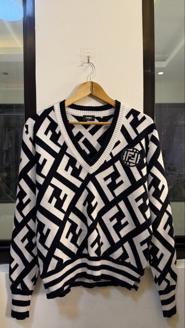 Fendi Roma FF Monogram V-Neck Sweater (Category: Coats, Jackets and Outerwear) located in Paranaque City. Submitted by preluxeshop_ph (Listing ID 1466763536, Image 2). Description: Fendi Roma FF Monogram V-Neck Sweater - Classic V-neck design - Timeless black and white colorway - Ribbed cuffs and hem for a comfortable fit - Made in Italy - Perfect for pairing with trousers or jeans L: 23.5” W: 19.5”.