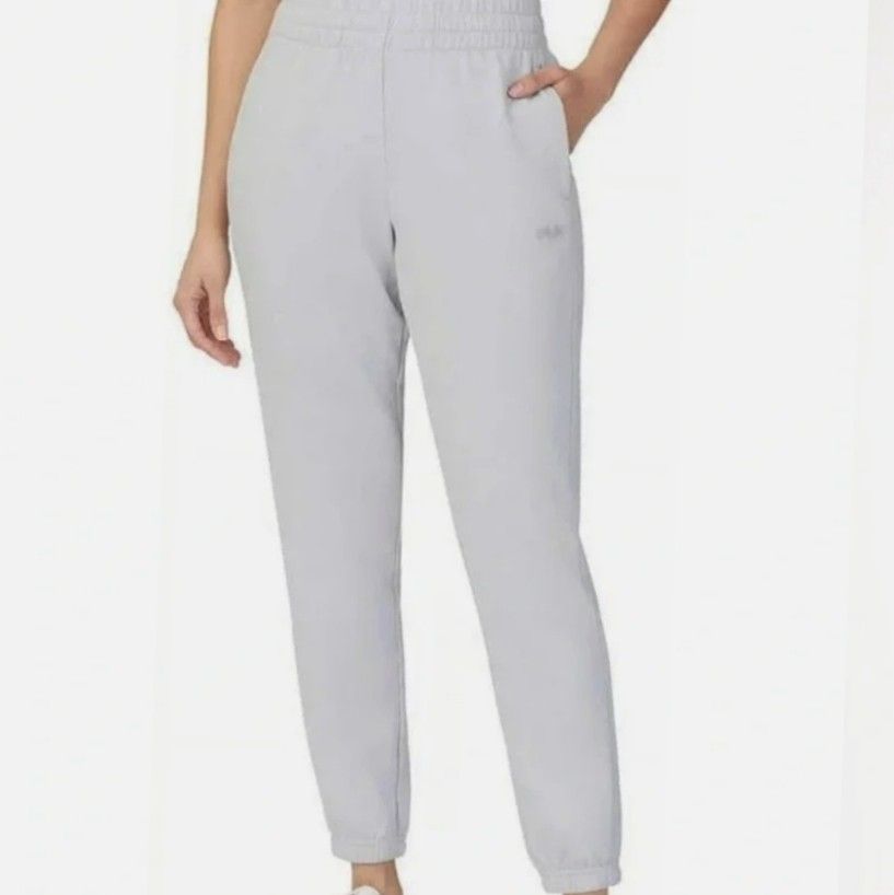 Fila Grey Jogger Sweatpants Size L (Category: Other Bottoms) located in Manila. Submitted by lene48 (Listing ID 1466692570, Image 1). Description: - Brand: Fila - Color: Light Grey - Size: L (Tag) - Material: Comfortable cotton - Fit: Relaxed fit with cuffed ankles - Waistband: Elastic with adjustable drawstring - Details: Small dotted Fila logo near the pocket - Origin: Made in Vietnam - Condition/Use: Ideal for casual daily wear.