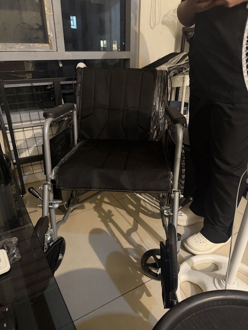 Foldable wheelchair with black mesh seat (Category: Wheelchairs) located in Quezon City. Submitted by lalaandkiki (Listing ID 1466581627, Image 1). Description: - Foldable silver metal frame for easy storage and transport - Breathable black mesh backrest and seat for comfort - Padded armrests included - Condition: Like new, with some parts still wrapped in plastic - Compact size fits easily in a car boot - Sturdy build, smooth and easy to maneuve