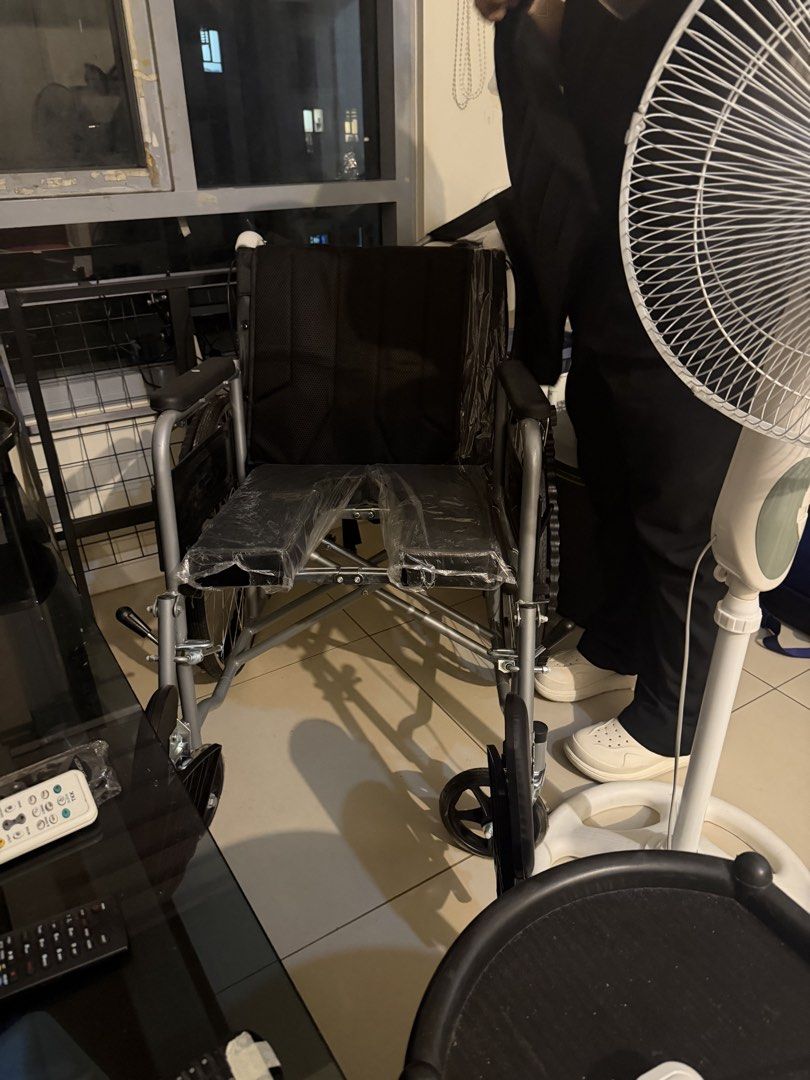 Foldable wheelchair with black mesh seat (Category: Wheelchairs) located in Quezon City. Submitted by lalaandkiki (Listing ID 1466581627, Image 2). Description: - Foldable silver metal frame for easy storage and transport - Breathable black mesh backrest and seat for comfort - Padded armrests included - Condition: Like new, with some parts still wrapped in plastic - Compact size fits easily in a car boot - Sturdy build, smooth and easy to maneuve