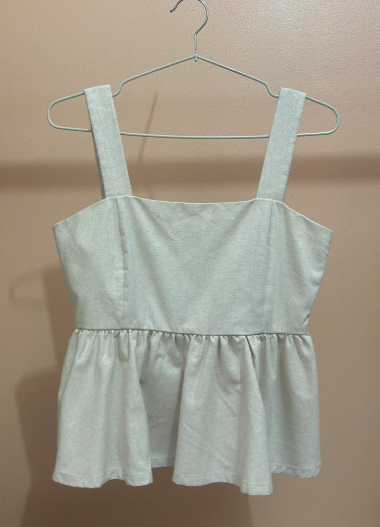 For Me Linen Peplum Top (Category: Sleeveless) located in Quezon City. Submitted by declutternstuff (Listing ID 1466139317, Image 2). Description: - Brand: Me Linen - Style: Peplum Top with square neckline and gathered waist - Color: Beige - Features: Thick shoulder straps, lightweight and breathable fabric - Condition: Brand new, unworn, clean and ready to wear - Original Retail Price: ₱1,298 - Perfect for: Warm weather casual outfits.