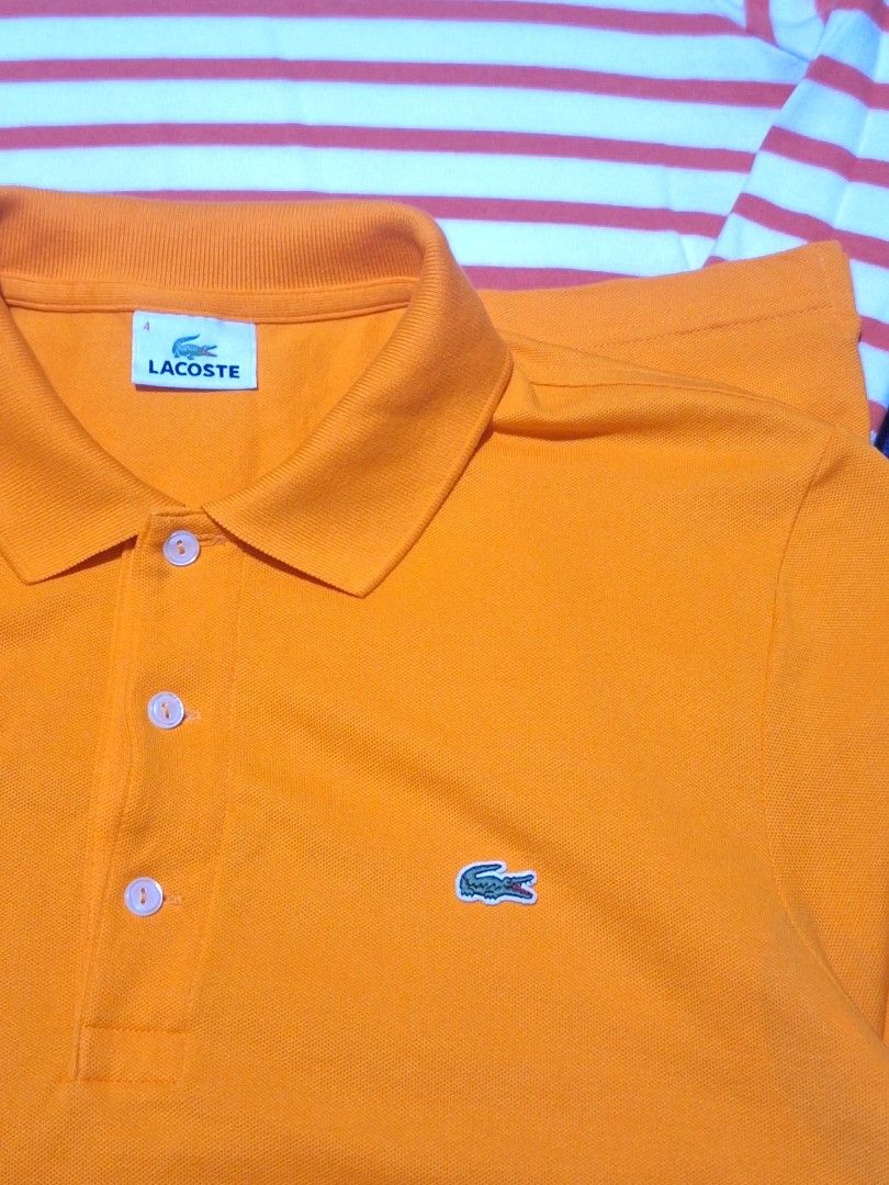 Forsale lacoste aspack size both medium (Category: Tshirts & Polo Shirts ) located in Manila. Submitted by adolphreyes645 (Listing ID 1466706005, Image 2). Description: - Authentic Lacoste bundle: 2 versatile pieces for daily casual wear - Piece 1: Bright orange polo shirt with classic embroidered crocodile logo and 3-button placket (Size 4 tag) - Piece 2: White long-sleeve shirt featuring stylish red horizontal stripes and small crocodile logo -