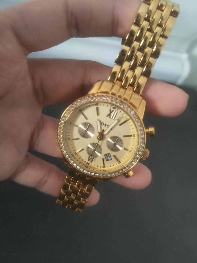 Fossil Gold Chronograph Crystal Bezel Watch (Category: Women's Watches) located in San Fernando. Submitted by pollygirl08 (Listing ID 1466605421, Image 3). Description: - Brand: Fossil (Model AAA 5692) - Color: Elegant gold-tone with a champagne dial - Design: Round face with dazzling crystal -No battery stones around the bezel - Features: 3 sub-dials and a convenient date window at the bottom right - Strap: Stainless steel link bracelet with sec