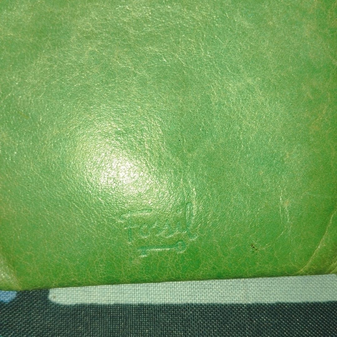 Fossil Green Leather Zip Around Wallet (Category: Wallets & Card holders) located in Manila. Submitted by lene48 (Listing ID 1466625397, Image 3). Description: - Brand: Fossil - Material: Genuine cow leather - Color: Mint green with colorful circle print lining - Features: Embossed logo on front, multiple built-in card slots, secure zip closure - Design: Compact and handy size, easily fits into bags for quick trips.