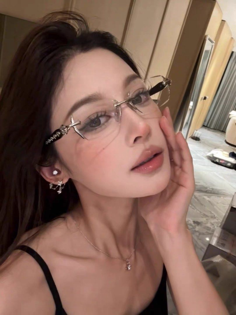 Frameless Glasses with Rhinestone Details (Category: Sunglasses & Eyewear) located in Taguig. Submitted by mengxir20193848 (Listing ID 1466688828, Image 1). Description: - Condition: Brand new, unworn with protective lenses intact - Protection: UV 400 clear lenses - Design: Lightweight, rimless/frameless look - Details: Black arms accented with rows of silver cross or star hardware - Comfort: Includes clear nose pads.