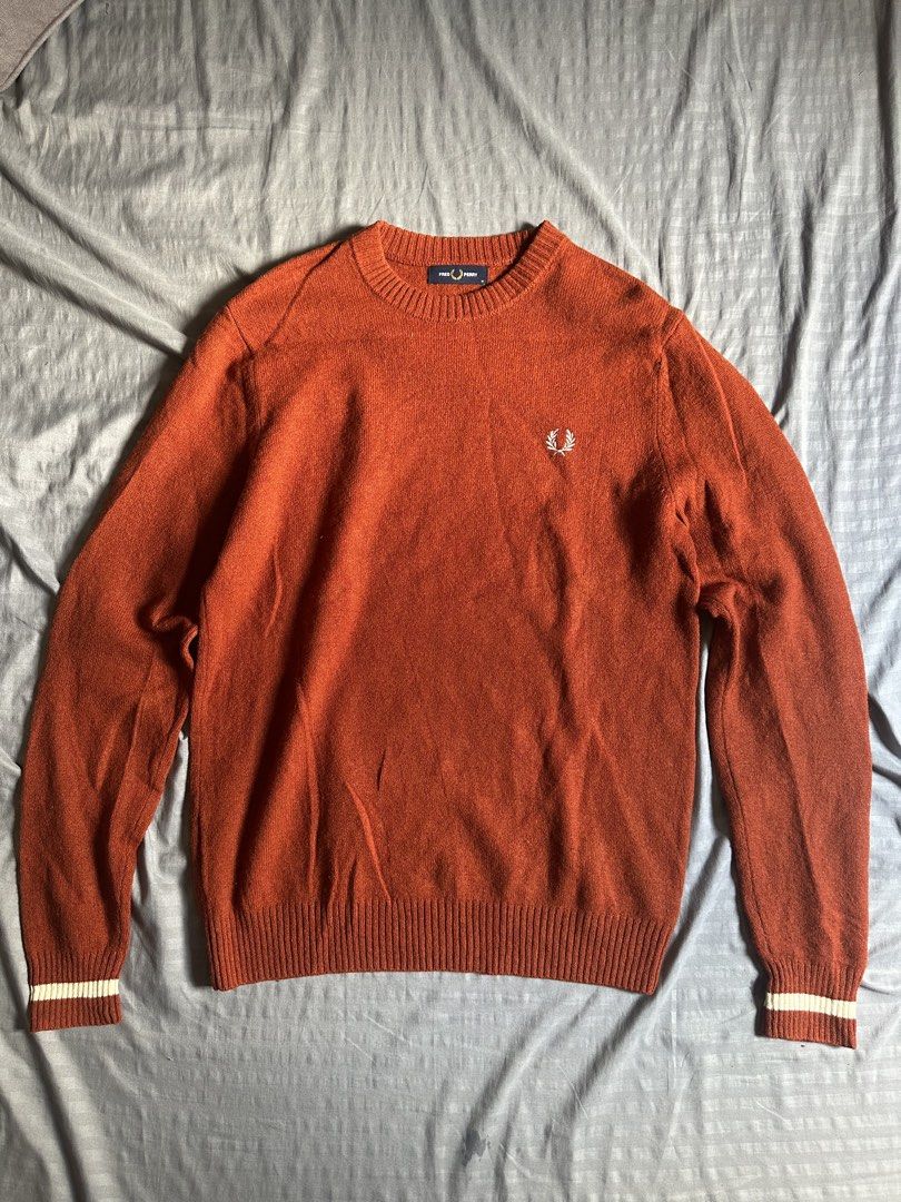 Fred Perry Rust Orange Crew Neck Sweater (Category: Coats, Jackets and Outerwear) located in Quezon City. Submitted by stre3tw3ar (Listing ID 1466624328, Image 1). Description: - Brand: Fred Perry - Style: Crew neck sweater / Style Code: K9535 - Color: Rich rust orange with contrast white stripe detailing on cuffs - Size: Medium (tag inside collar) - Features: Iconic embroidered laurel wreath logo on left chest, ribbed cuffs and hem - Material: S