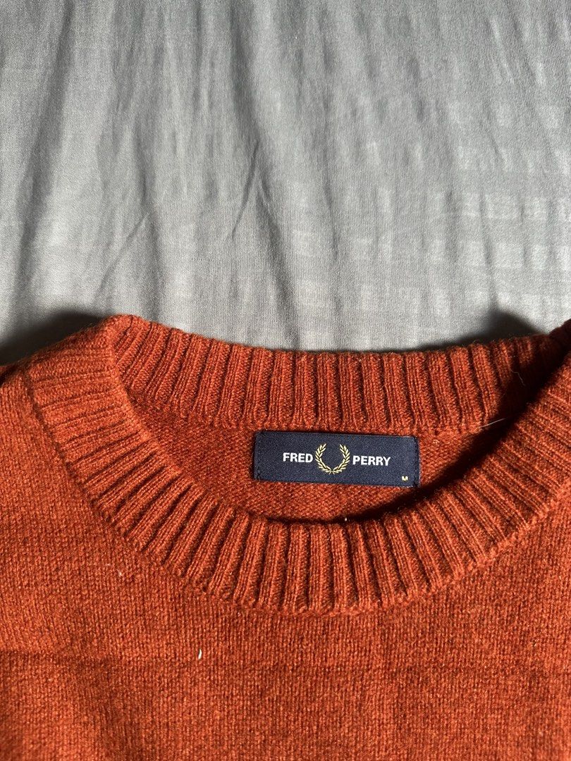 Fred Perry Rust Orange Crew Neck Sweater (Category: Coats, Jackets and Outerwear) located in Quezon City. Submitted by stre3tw3ar (Listing ID 1466624328, Image 3). Description: - Brand: Fred Perry - Style: Crew neck sweater / Style Code: K9535 - Color: Rich rust orange with contrast white stripe detailing on cuffs - Size: Medium (tag inside collar) - Features: Iconic embroidered laurel wreath logo on left chest, ribbed cuffs and hem - Material: S