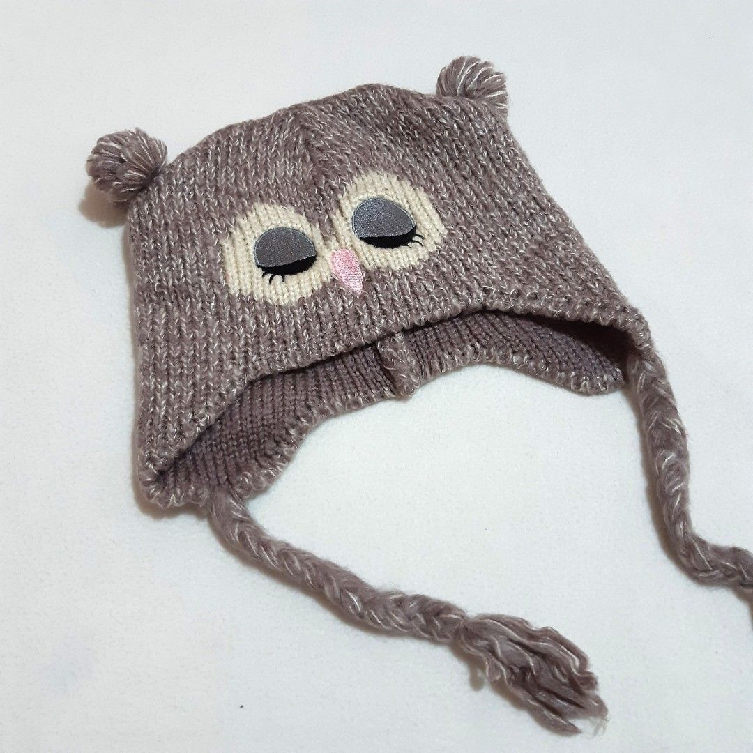 Funky Fish Owl Knitted Beanie Hat with Earflaps (Category: Hats & Beanies) located in Tuguegarao City. Submitted by thriftedtreasures101.1 (Listing ID 1466645526, Image 1). Description: Playful and quirky style beanie hat. It features a knitted eye patches with close eyelids, a tiny pink triangle beak, small ear-like tufts, braided earflap cords and a subtle metallic or glitter thread woven into the knit. Slightly used, in good condition. Size Me