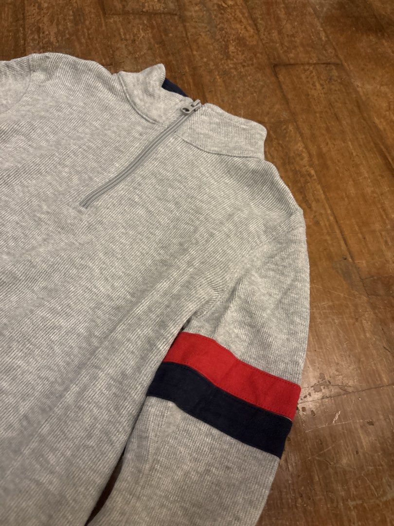 Gap Kids Grey 1/4 Zip Sweater Size S (Category: Babies & Kids Fashion) located in Makati City. Submitted by shoplecloset (Listing ID 1466683444, Image 2). Description: - Brand/Model: Gap Kids Grey Quarter-Zip Sweater - Size: S - Material: Ribbed knit - Design Details: Red and navy blue stripes on both sleeves, high collar with zipper closure, and small Gap 1969 tag near bottom hem - Origin: Made in Vietnam - Condition: Clean and ready to wear - f