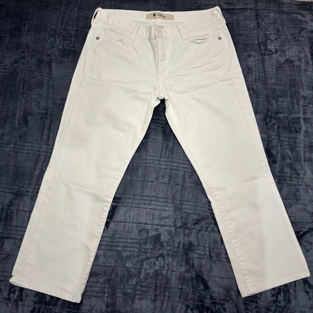 GAP Original Low Rise White Jeans (Category: Jeans) located in Balayan. Submitted by authenticfindsbymrb (Listing ID 1466710171, Image 1). Description: - Brand: GAP (100% Original) - Style: Low-rise, straight-cut pants - Color: Solid White - Material: Cotton and spandex blend (soft with stretch for all-day comfort) - Features: Classic 5-pocket design, belt loops, button closure, and trendy flap back pockets with metal rivets - Perfect for effortl