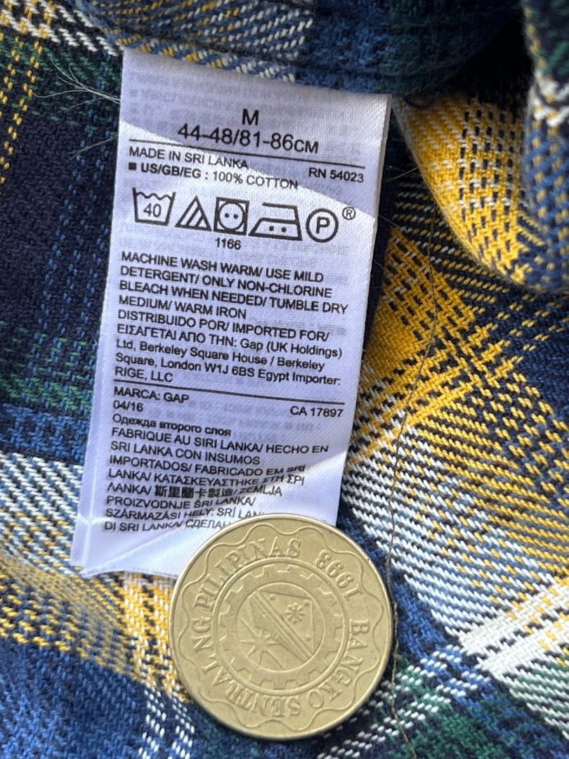 Gap x Pendleton Plaid Flannel Shirt Medium (Category: Tshirts & Polo Shirts ) located in Caloocan City. Submitted by sillapwet0606 (Listing ID 1466565923, Image 3). Description: - Brand: Gap x Pendleton collaboration - Size: Medium regular fit - Pattern: Navy blue, yellow, and green plaid - Material: Thick, warm fabric ideal for cooler weather - Design: Classic button-down front with two chest pockets - Origin: Made in Sri Lanka.