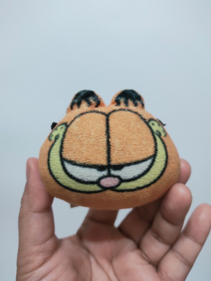 Garfield Head Plush Charm (preloved) (Category: Plushies & Soft Toys) located in Antipolo. Submitted by bhabiegraciefashionlab (Listing ID 1466574789, Image 1). Description: 💜✨Garfield Head Plush Charm (preloved)✨💜 🇯🇵Authentic From Japan 📸Actual Photos posted, what you see is what you'll get 😍Perfect for Garfield fans/collectors or for gifting 🔖preloved but still in good condition, faded lng etiketa nya 💸MOP 👉🏻Gcash /Maribank/GoTyme 🚚M