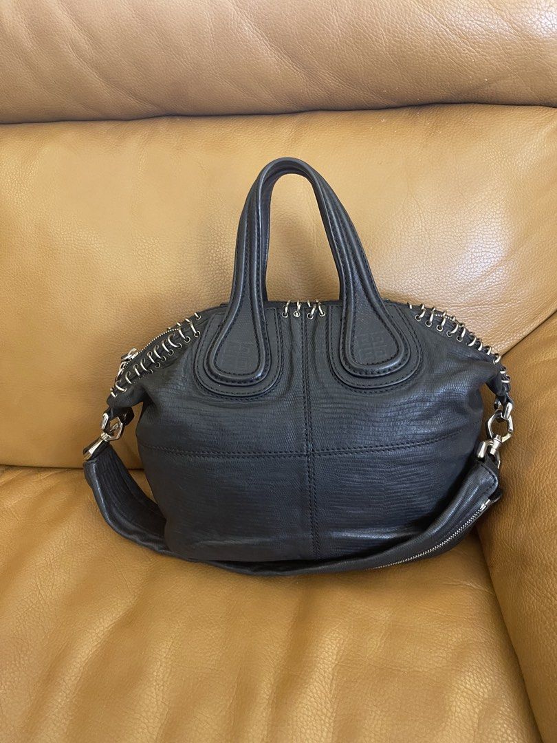 Givenchy Black Leather Handbag with Metal Ring Details (Category: Luxury Bags & Wallets) located in Manila. Submitted by cuaresmahajji (Listing ID 1466673048, Image 2). Description: - Authentic Givenchy black leather handbag with chic textured pattern - Silver-tone hardware featuring decorative metal rings along the zipper line - Dual structured top handles plus a convenient detachable shoulder strap - Clean and well-kept interior and exterior - 