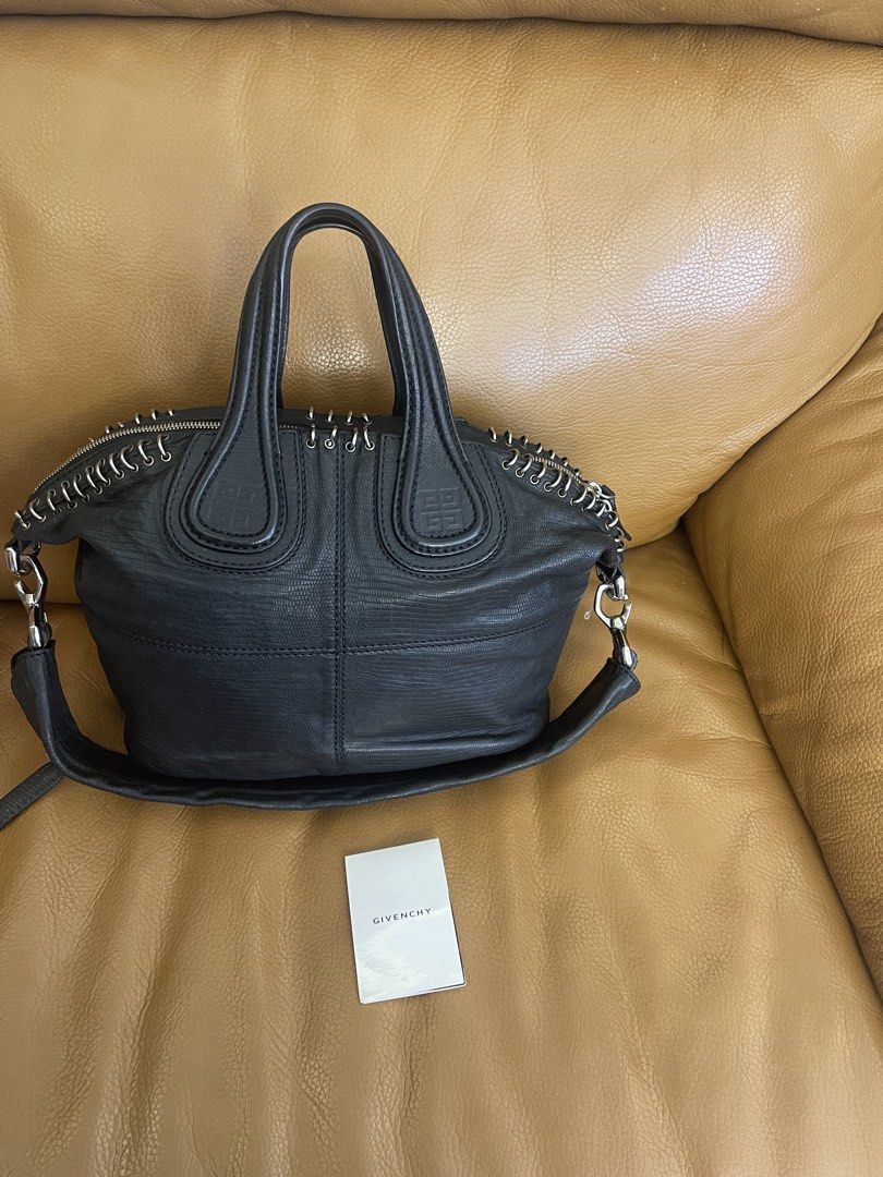 Givenchy Black Leather Handbag with Metal Ring Details (Category: Luxury Bags & Wallets) located in Manila. Submitted by cuaresmahajji (Listing ID 1466673048, Image 1). Description: - Authentic Givenchy black leather handbag with chic textured pattern - Silver-tone hardware featuring decorative metal rings along the zipper line - Dual structured top handles plus a convenient detachable shoulder strap - Clean and well-kept interior and exterior - 