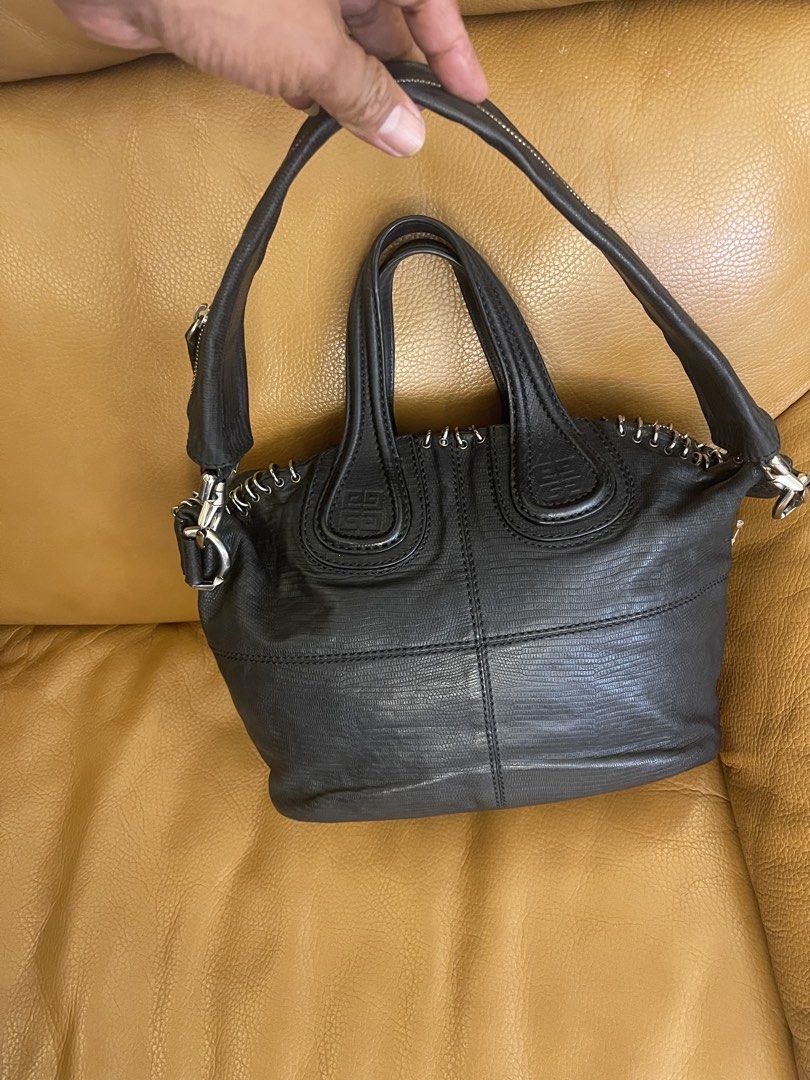 Givenchy Black Leather Handbag with Metal Ring Details (Category: Luxury Bags & Wallets) located in Manila. Submitted by cuaresmahajji (Listing ID 1466673048, Image 3). Description: - Authentic Givenchy black leather handbag with chic textured pattern - Silver-tone hardware featuring decorative metal rings along the zipper line - Dual structured top handles plus a convenient detachable shoulder strap - Clean and well-kept interior and exterior - 