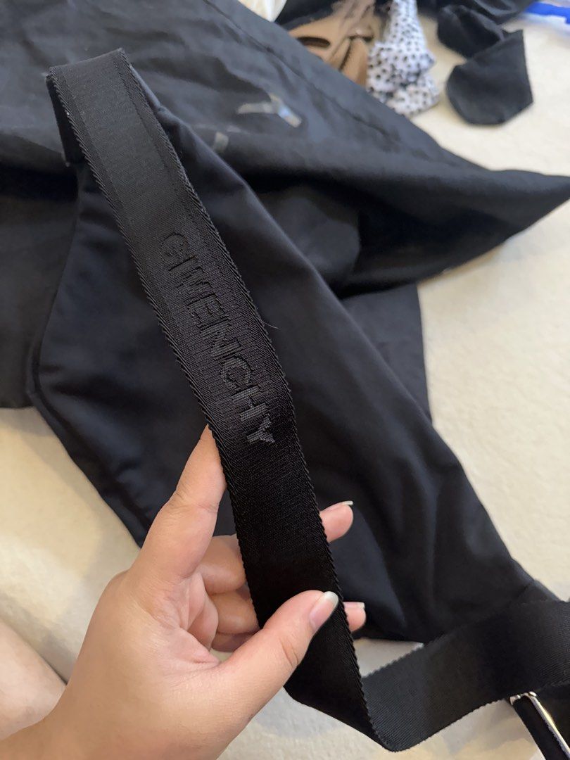 Givenchy Black Nylon Logo Sling Bag (Category: Luxury Bags & Wallets) located in Manila. Submitted by janeca__ (Listing ID 1466769029, Image 2). Description: - Brand: Givenchy - Material: Durable black nylon with silver-tone hardware - Design: White embroidered logo on flap, metallic front branding - Compartments: Spacious main compartment and front zipper pocket - Strap: Adjustable woven strap with embossed Givenchy text - Inclusions: Comes with