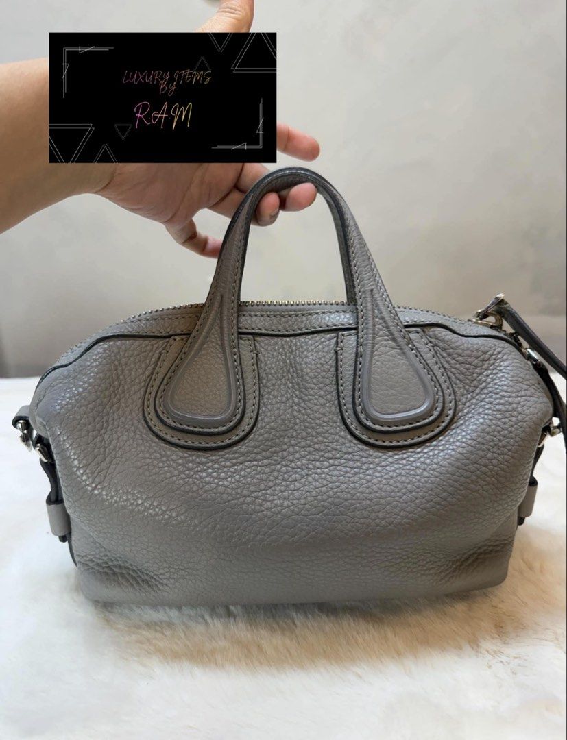 Givenchy Grey Leather Handbag (Category: Luxury Bags & Wallets) located in Manila. Submitted by rhea.1215 (Listing ID 1466694034, Image 2). Description: - Brand: Givenchy - Material: Soft pebbled grey leather - Closure: Top zipper with metal hardware - Handles: Double top handles plus side rings for a strap - Condition/Details: Clean stitching along seams and corners - Size: Compact, perfect for daily essentials - Style: Neutral grey color that m
