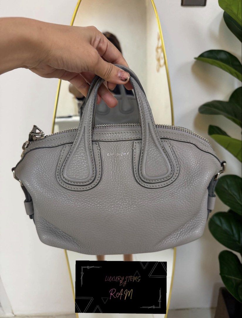 Givenchy Grey Leather Handbag (Category: Luxury Bags & Wallets) located in Manila. Submitted by rhea.1215 (Listing ID 1466694034, Image 1). Description: - Brand: Givenchy - Material: Soft pebbled grey leather - Closure: Top zipper with metal hardware - Handles: Double top handles plus side rings for a strap - Condition/Details: Clean stitching along seams and corners - Size: Compact, perfect for daily essentials - Style: Neutral grey color that m