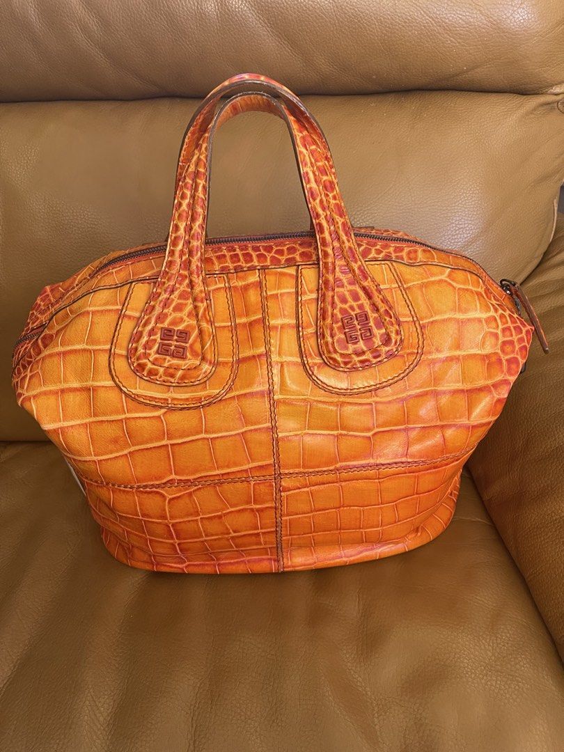 Givenchy Orange Croc Embossed Leather Handbag (Category: Luxury Bags & Wallets) located in Manila. Submitted by cuaresmahajji (Listing ID 1466672840, Image 3). Description: - Brand: Givenchy - Color: Bright orange - Material: Premium crocodile-embossed leather - Closure: Top zip closure with double top handles - Details: Monogram stamped near handle base and sturdy side hardware - Base: Structured oval base with distinct scale patterning - Style:
