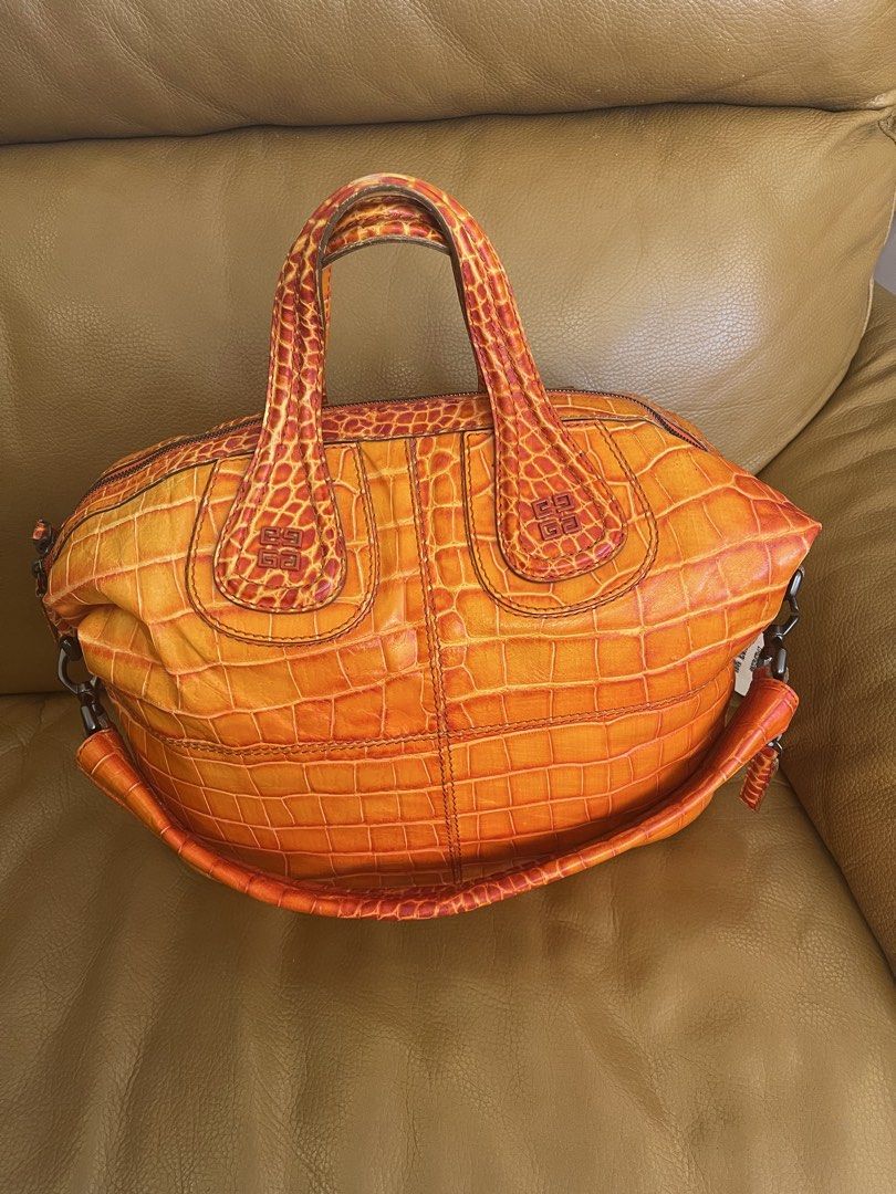 Givenchy Orange Croc Embossed Leather Handbag (Category: Luxury Bags & Wallets) located in Manila. Submitted by cuaresmahajji (Listing ID 1466672840, Image 1). Description: - Brand: Givenchy - Color: Bright orange - Material: Premium crocodile-embossed leather - Closure: Top zip closure with double top handles - Details: Monogram stamped near handle base and sturdy side hardware - Base: Structured oval base with distinct scale patterning - Style: