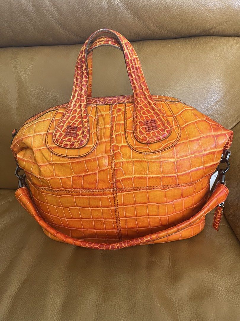 Givenchy Orange Croc Embossed Leather Handbag (Category: Luxury Bags & Wallets) located in Manila. Submitted by cuaresmahajji (Listing ID 1466672840, Image 2). Description: - Brand: Givenchy - Color: Bright orange - Material: Premium crocodile-embossed leather - Closure: Top zip closure with double top handles - Details: Monogram stamped near handle base and sturdy side hardware - Base: Structured oval base with distinct scale patterning - Style: