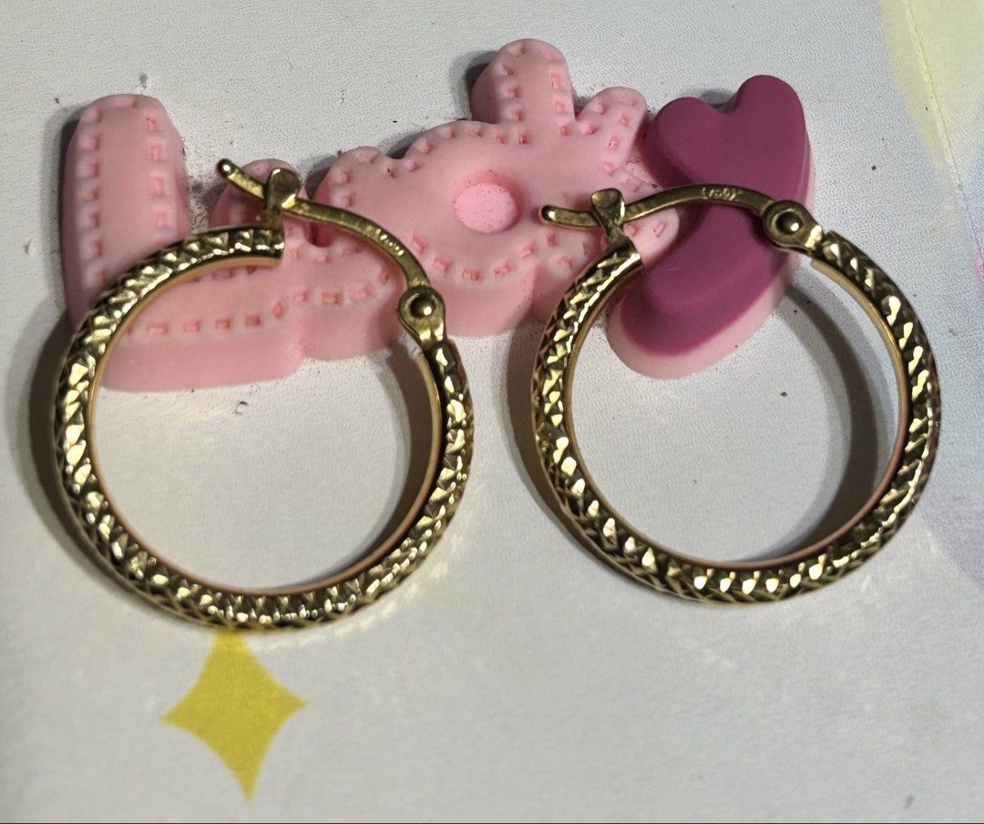 Gold textured hoop earrings (Category: Earrings) located in Manila. Submitted by starry_sun1607 (Listing ID 1466717924, Image 1). Description: - Textured gold hoop earrings with intricate cut patterns - Secure clasp closure for worry-free wear - Versatile medium size ideal for daily outfits - Clean, polished metal finish that catches the light - Classic round shape suitable for any occasion.