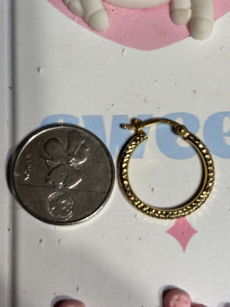 Gold textured hoop earrings (Category: Earrings) located in Manila. Submitted by starry_sun1607 (Listing ID 1466717924, Image 2). Description: - Textured gold hoop earrings with intricate cut patterns - Secure clasp closure for worry-free wear - Versatile medium size ideal for daily outfits - Clean, polished metal finish that catches the light - Classic round shape suitable for any occasion.