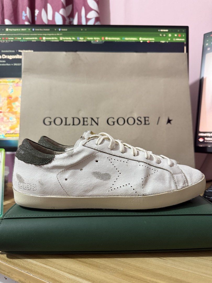 Golden Goose White Leather Sneakers (Category: Sneakers) located in Las Pinas. Submitted by bujetbujit (Listing ID 1466772877, Image 1). Description: - Brand: Golden Goose - Color: White with dark textured heel tab and cream laces - Condition/Style: Signature distressed finish for that worn-in luxury look - Details: Perforated star logo on the side, white logo lettering on heel - Sole: Durable rubber with herringbone tread pattern - Inclusions: O