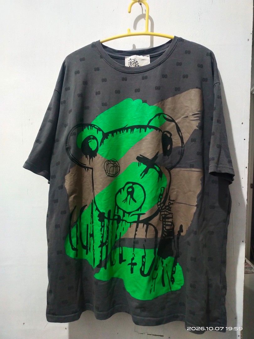 Graphic Print T-Shirt with Bear and D/D Monogram (Category: Shirts) located in Manila. Submitted by rhobin.m08 (Listing ID 1466684034, Image 1). Description: - Color/Pattern: Dark grey with all-over micro monogram print - Design: Large abstract bear graphic with green and brown block accents - Fit/Style: Relaxed fit, short sleeves, and classic crew neck - Material: Soft and comfortable cotton for everyday wear - Condition: with tag stitched insid