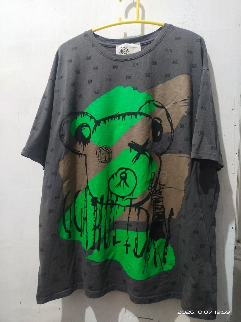 Graphic Print T-Shirt with Bear and D/D Monogram (Category: Shirts) located in Manila. Submitted by rhobin.m08 (Listing ID 1466684034, Image 2). Description: - Color/Pattern: Dark grey with all-over micro monogram print - Design: Large abstract bear graphic with green and brown block accents - Fit/Style: Relaxed fit, short sleeves, and classic crew neck - Material: Soft and comfortable cotton for everyday wear - Condition: with tag stitched insid