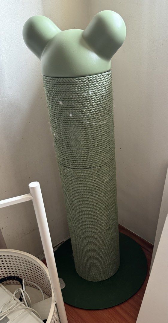 Green Cat Scratching Post with Mouse Ears (Category: Homes & Other Pet Accessories) located in Makati City. Submitted by lovejuju72 (Listing ID 1466569655, Image 1). Description: - Green cat scratching post wrapped in thick, durable rope - Cute rounded top shaped like mouse ears - Sturdy dark green circular base for great stability - Provides a dedicated spot for cats to scratch and stretch - Condition: Good, with some cat hair trapped in the rop