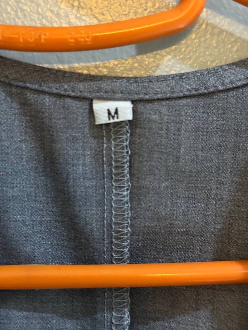 Grey cropped waistcoat vest size M (Category: Sleeveless) located in Taguig. Submitted by anxmz (Listing ID 1466676639, Image 2). Description: - Size: Medium - Color: Grey - Design: V-neck with 3 black front buttons and cropped length - Details: Neat stitching along the back seam, unbranded basic piece - Styling: Great layering item for both casual and smart outfits.