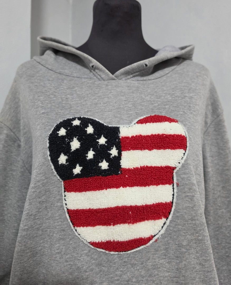 Grey Hoodie American Flag Mickey Mouse Patch Pocket (Category: Coats, Jackets and Outerwear) located in Paranaque City. Submitted by franinnashop (Listing ID 1466622363, Image 2). Description: DECLUTTER LARGE TO XL ISSUE LAST PHOTO AND WALA NA UNG STRING SA HOOD PARANAQUE CITY -Grey pullover hoodie with a prominent embroidered American flag Mickey Mouse patch on the chest. Classic front kangaroo pocket, ribbed cuffs and hem. Relaxed, comfortable 